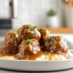 Slow Cooker Salisbury Steak Meatballs plated with rich gravy on a modern kitchen counter