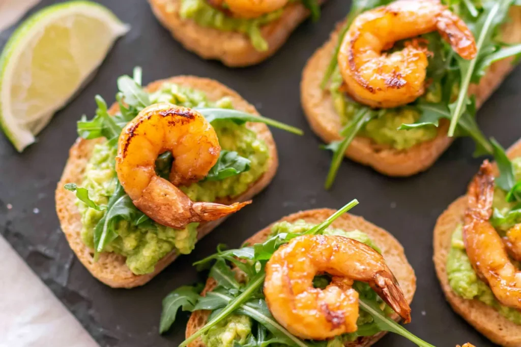 Garlic Shrimp Avocado Crostini for a Crisp, Creamy Party Bite 7 Spiced shrimp for Garlic Shrimp Avocado Crostini served on crisp avocado toasts