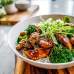 photorealistic teriyaki chicken broccoli plated in a modern kitchen