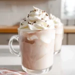 whipped hot chocolate hero shot with fluffy whipped topping in modern kitchen