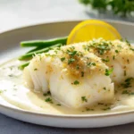 baked cod with lemon cream served on a modern plate
