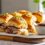 Best French Dip Sliders served with au jus on a modern plate