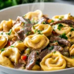 cheesesteak tortellini FlavorFit Kitchen served with creamy provolone sauce