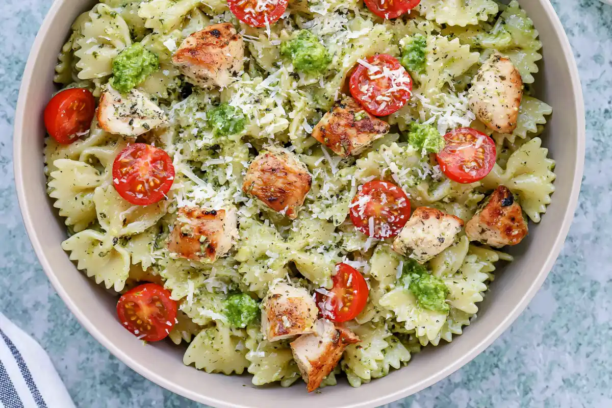 Chicken Pesto Pasta with a Creamy 30-Minute Sauce 1 Mohamed Ayad's Chicken Pesto Pasta Recipe with creamy pesto sauce, seasoned chicken, cherry tomatoes, basil, and Parmesan