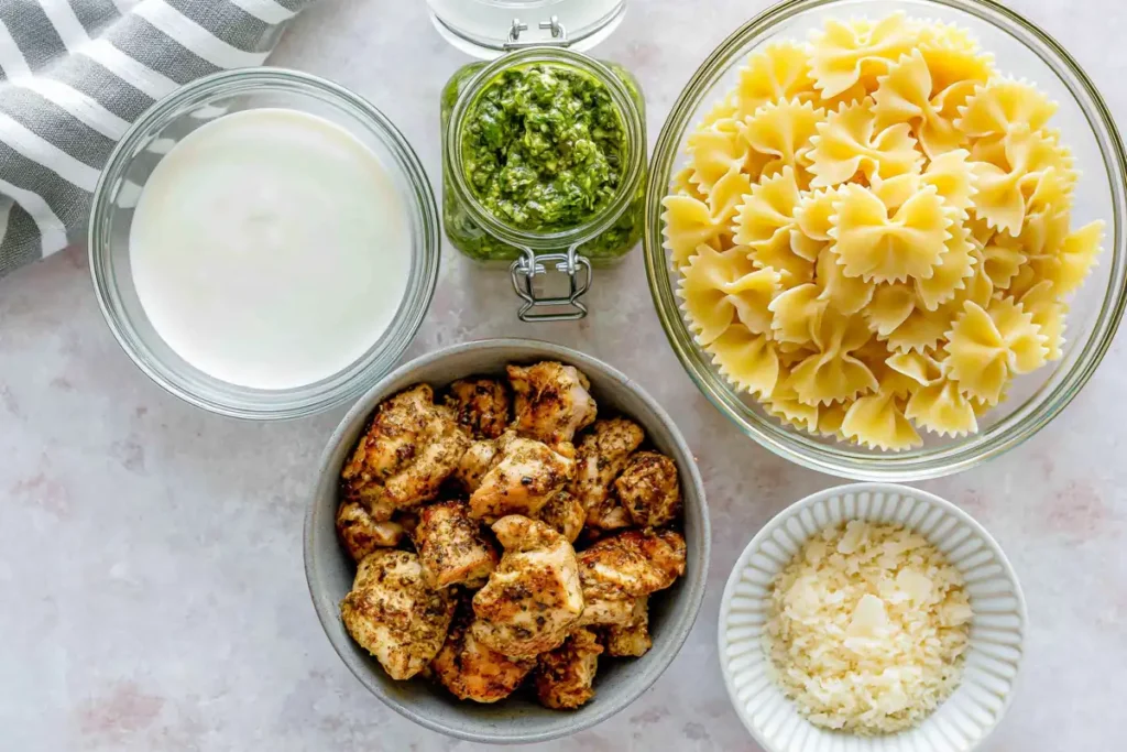Chicken Pesto Pasta with a Creamy 30-Minute Sauce 5 Pasta, reserved cooking water, pesto, cream, Parmesan, and chicken prepared for Chicken Pesto Pasta