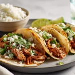 Chicken Street Tacos served on a modern plate with fresh cilantro and lime