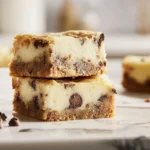 Finished Chocolate Chip Cookie Cheesecake Bars plated as a hero shot in a modern kitchen