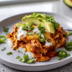 Crockpot Chicken Enchilada Casserole served hot with melted cheese and enchilada sauce