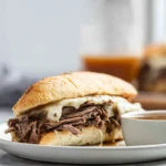 Crockpot French Dip Sandwiches served with melted provolone and au jus