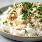 Crockpot Ranch Chicken plated with creamy sauce and fresh herbs