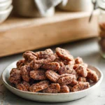 Easy Candied Pecans served on a ceramic plate in a cozy home kitchen