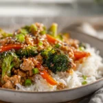 Photorealistic bowl of Ground Turkey Teriyaki Stir Fry on modern kitchen counter