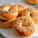 Homemade bagels hero shot with glossy sesame seeds and cream cheese in a modern kitchen
