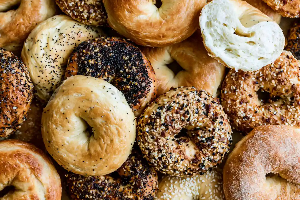 Mohamed Ayad's Homemade Bagels Recipe with golden chewy bagels on a wooden board