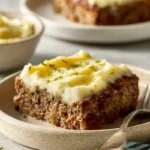 Meatloaf with mashed potatoes served on a modern plate in natural light