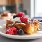 photorealistic overnight crème brûlée french toast on modern plate with berries and caramelized sugar topping