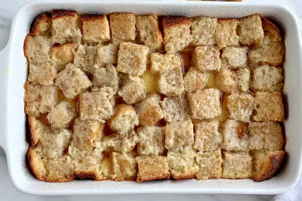 Overnight-soaked bread cubes ready to bake for Overnight Crème Brûlée French Toast