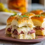 Reuben Sliders baked with corned beef, Swiss cheese, and sauerkraut
