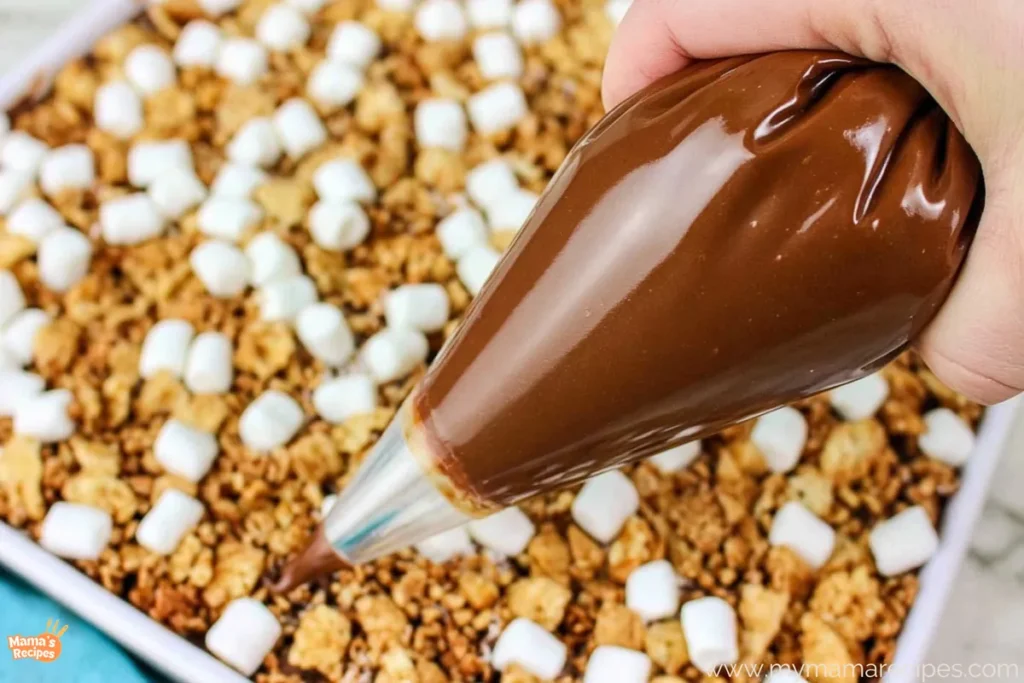 S’mores Snack Mix for an Easy No-Bake Treat 6 Melted milk chocolate prepared for drizzling over S’mores Snack Mix