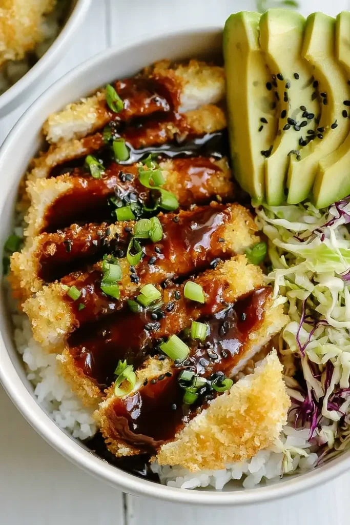 Japanese Katsu Bowls with Crispy Sheet-Pan Chicken 2 Japanese Katsu Bowls with crispy panko chicken, rice, cabbage slaw, avocado, scallions, and sesame seeds