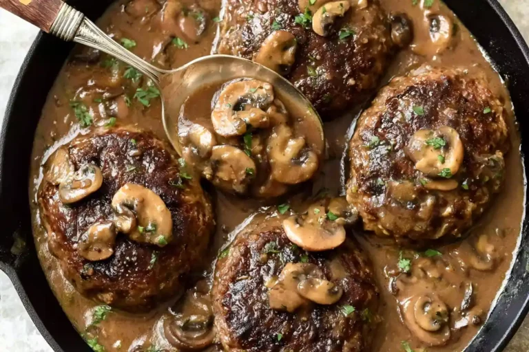 Mohamed Ayad's Salisbury Steak Recipe with Mushroom Gravy in a Cast-Iron Skillet