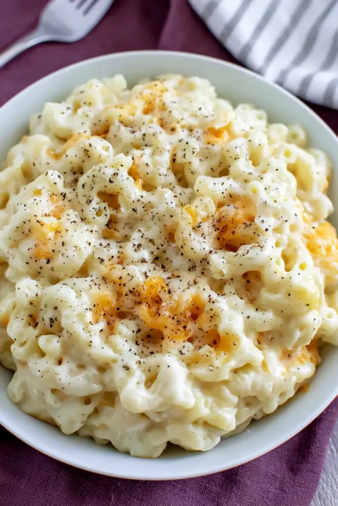 Homemade Baked Mac and Cheese with a Creamy Layered Center 4 Creamy Homemade Baked Mac and Cheese served in a white bowl