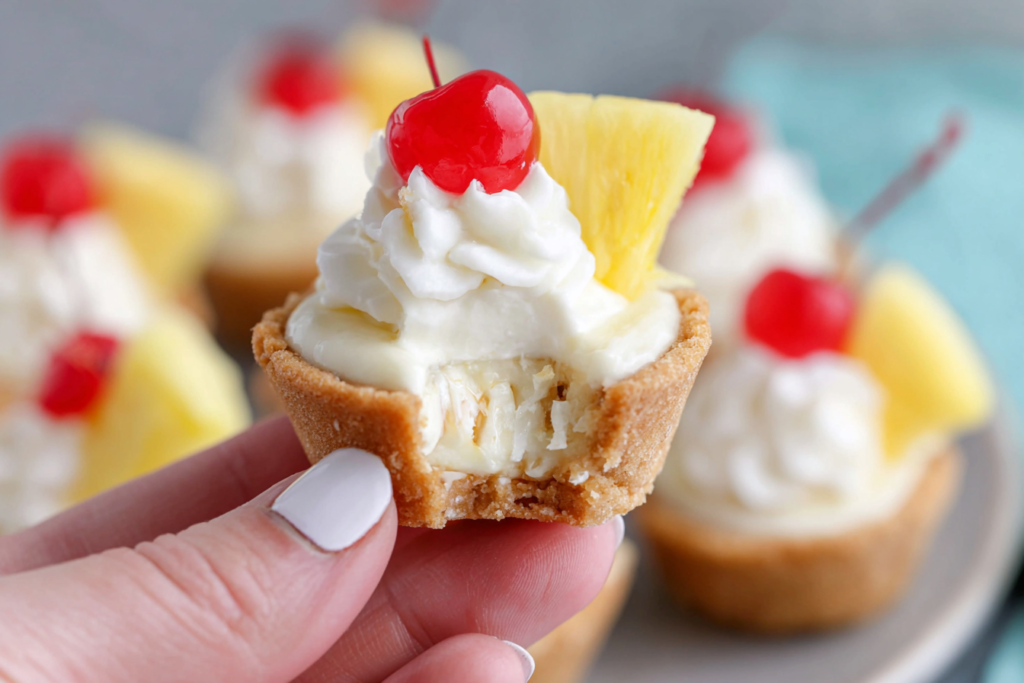 Close-up of a bitten Pina Colada Cookie Cups dessert with creamy pineapple filling