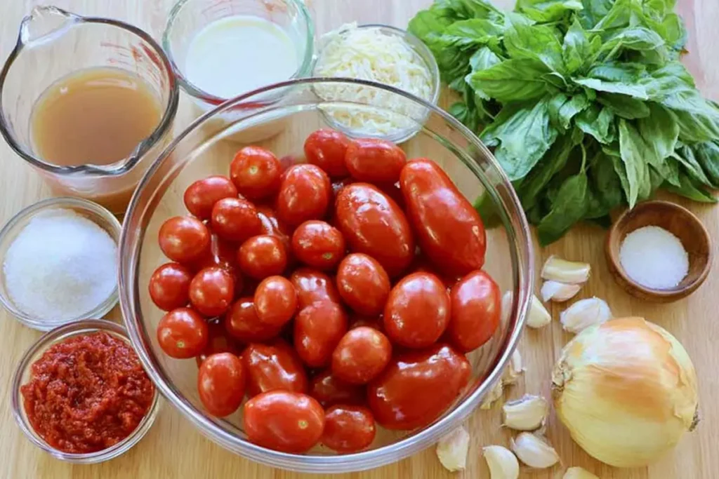 Roasted Tomato Soup with Rich Oven-Roasted Flavor 11 Fresh ingredients for roasted tomato soup with tomatoes, basil, garlic, broth, and Parmesan