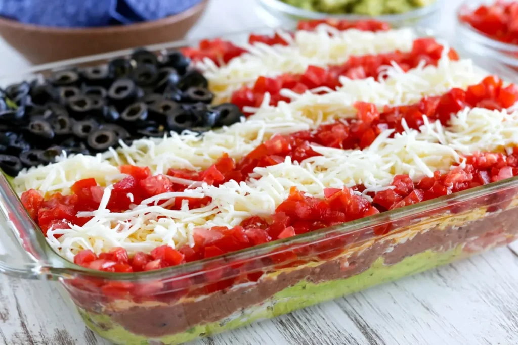Finished American flag layered taco dip ready to chill before serving