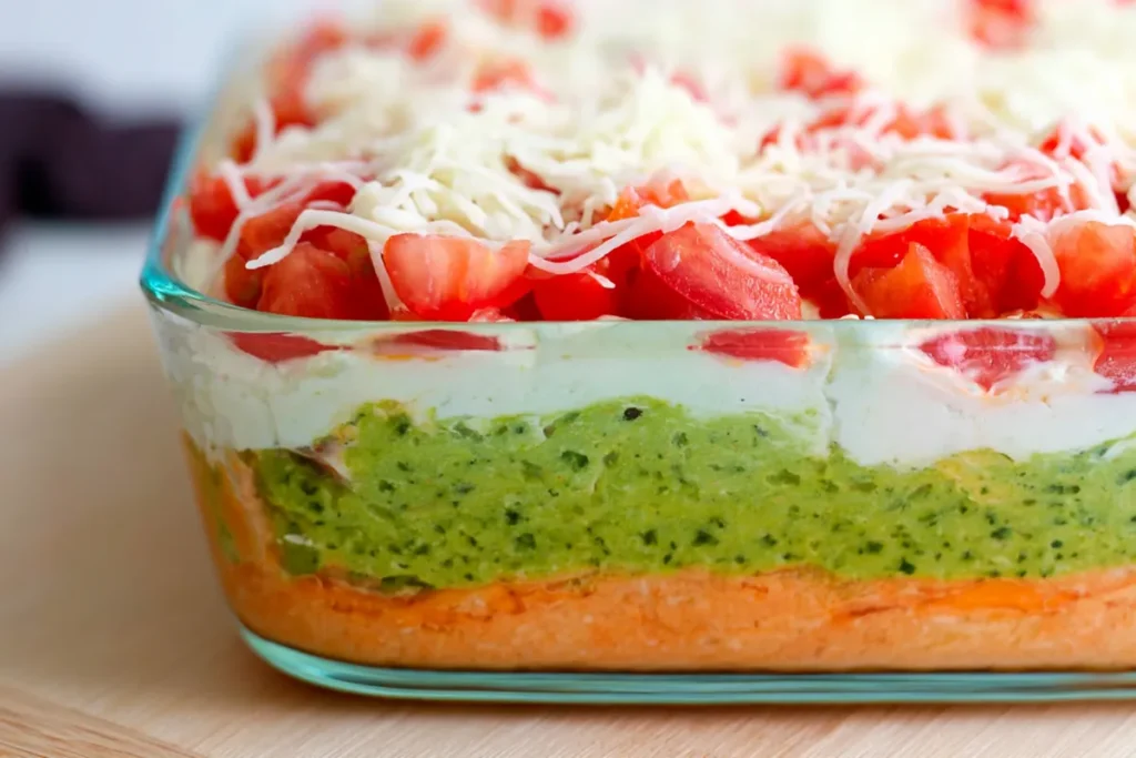 Side view of American flag layered taco dip showing beans guacamole and sour cream layers