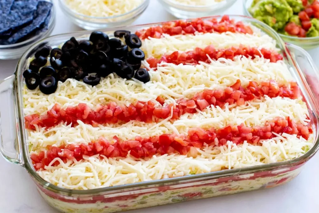 American flag layered taco dip served with blue corn tortilla chips