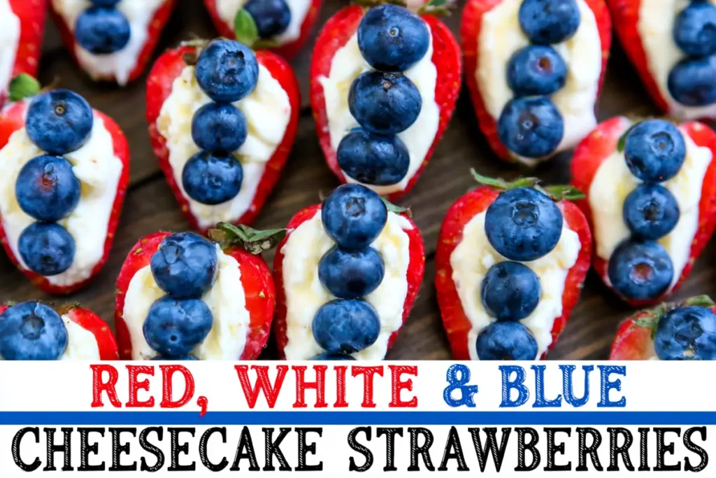 Cheesecake stuffed strawberries arranged on a party board with blueberries