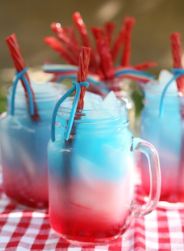 Patriotic punch with red white and blue layers and candy straws